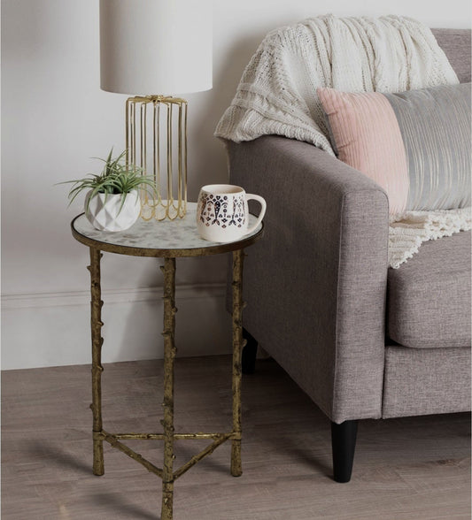 Small round side table, perfect for a bedroom or reading nook.
