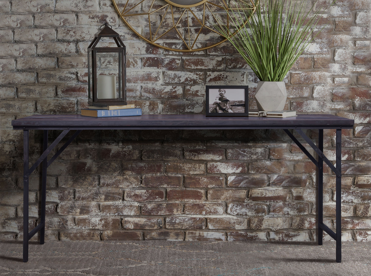 Rustic folding table against a brick wall with décor