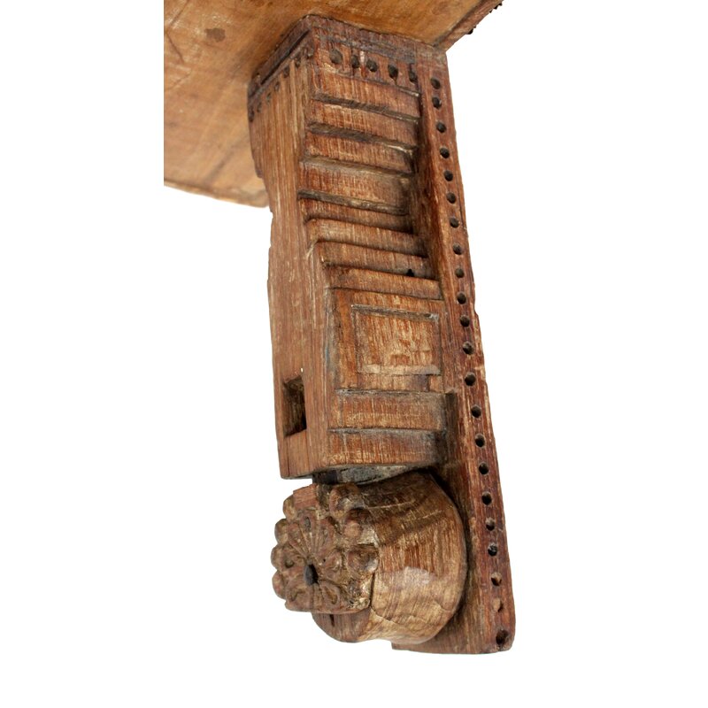 Carved wooden stand bracket detail.