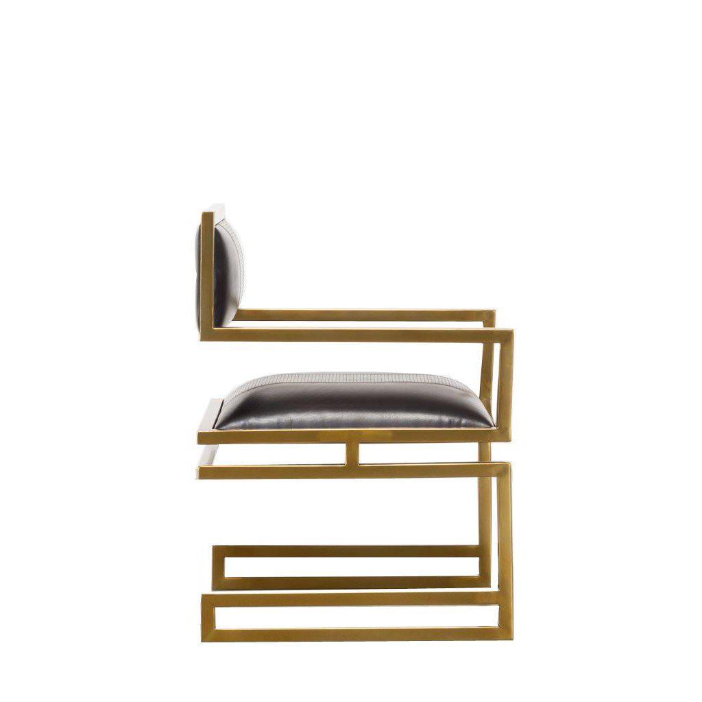 Close-up of gold frame and leather seat.
