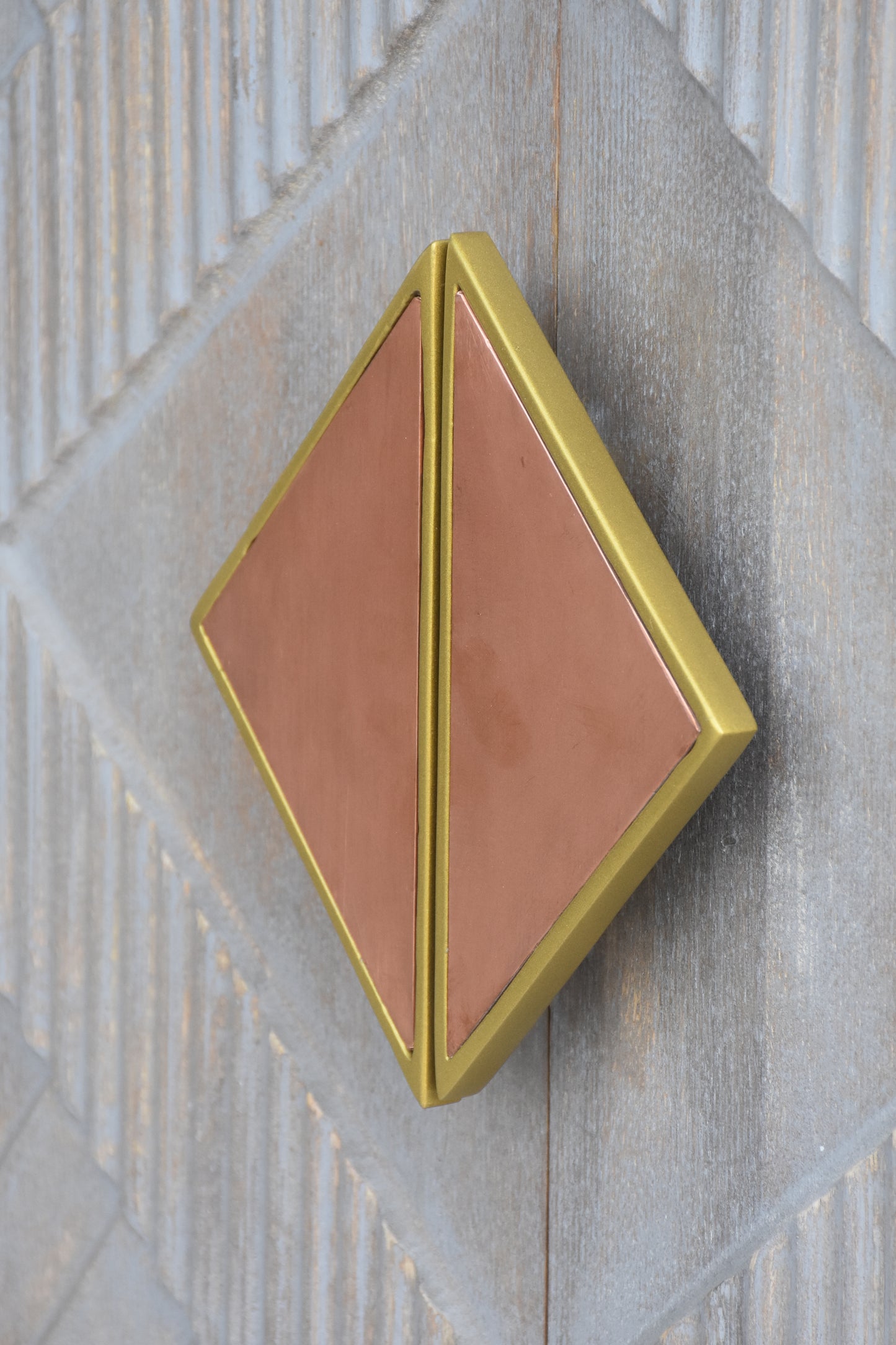 Detailed view of the cabinet's decorative handle design.