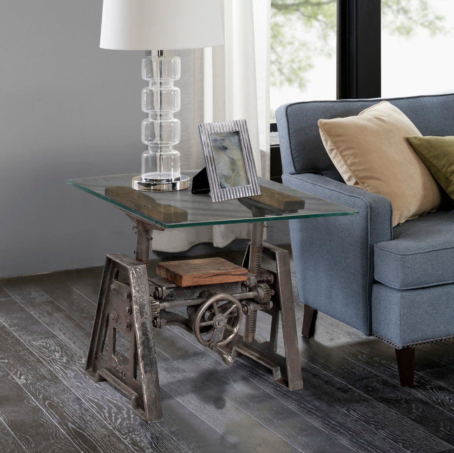 Industrial end table with glass top in a modern living room.