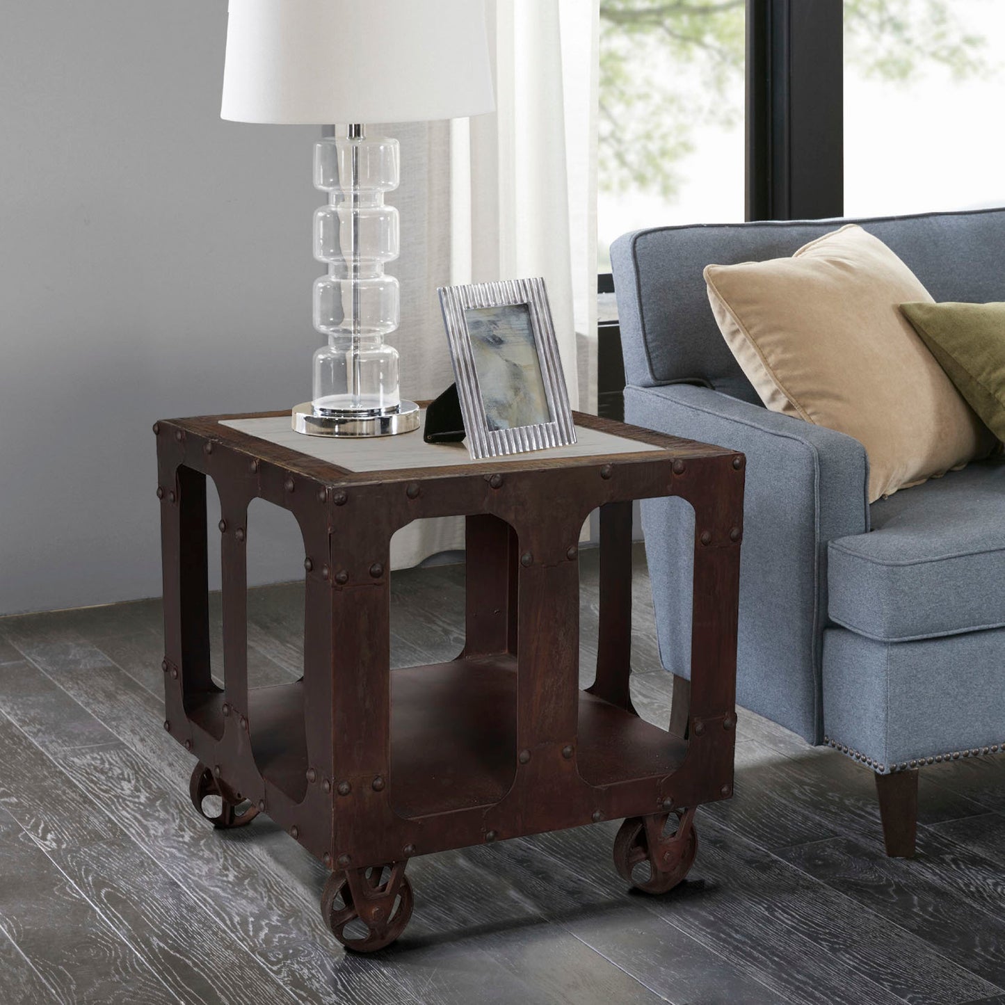 End table placed near a sofa with decor items.