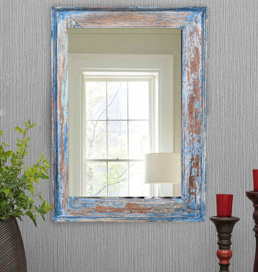 Rustic blue antique mirrors reflecting a bright room.