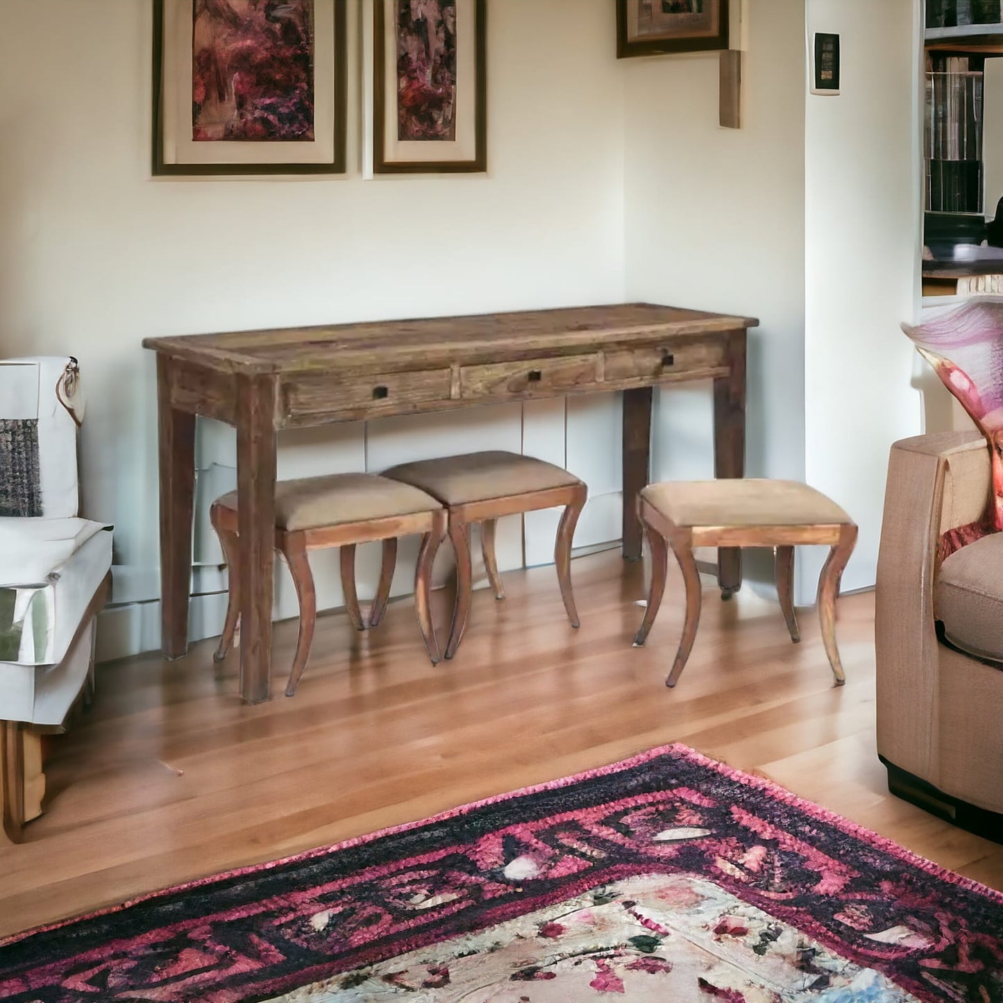 Elegant sofa table with stools in a living room setting.