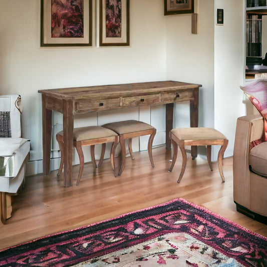 Elegant sofa table with stools in a living room setting.