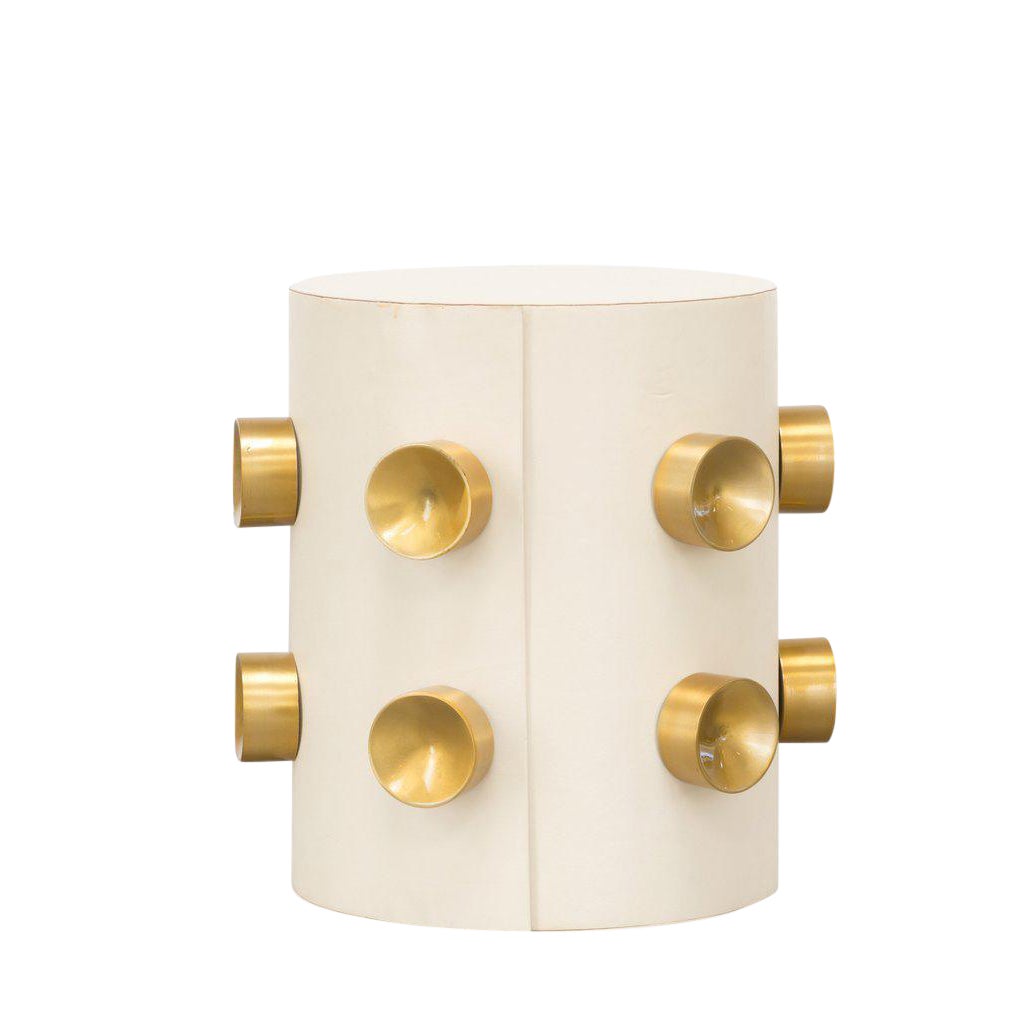 White leather end table with gold buttons.