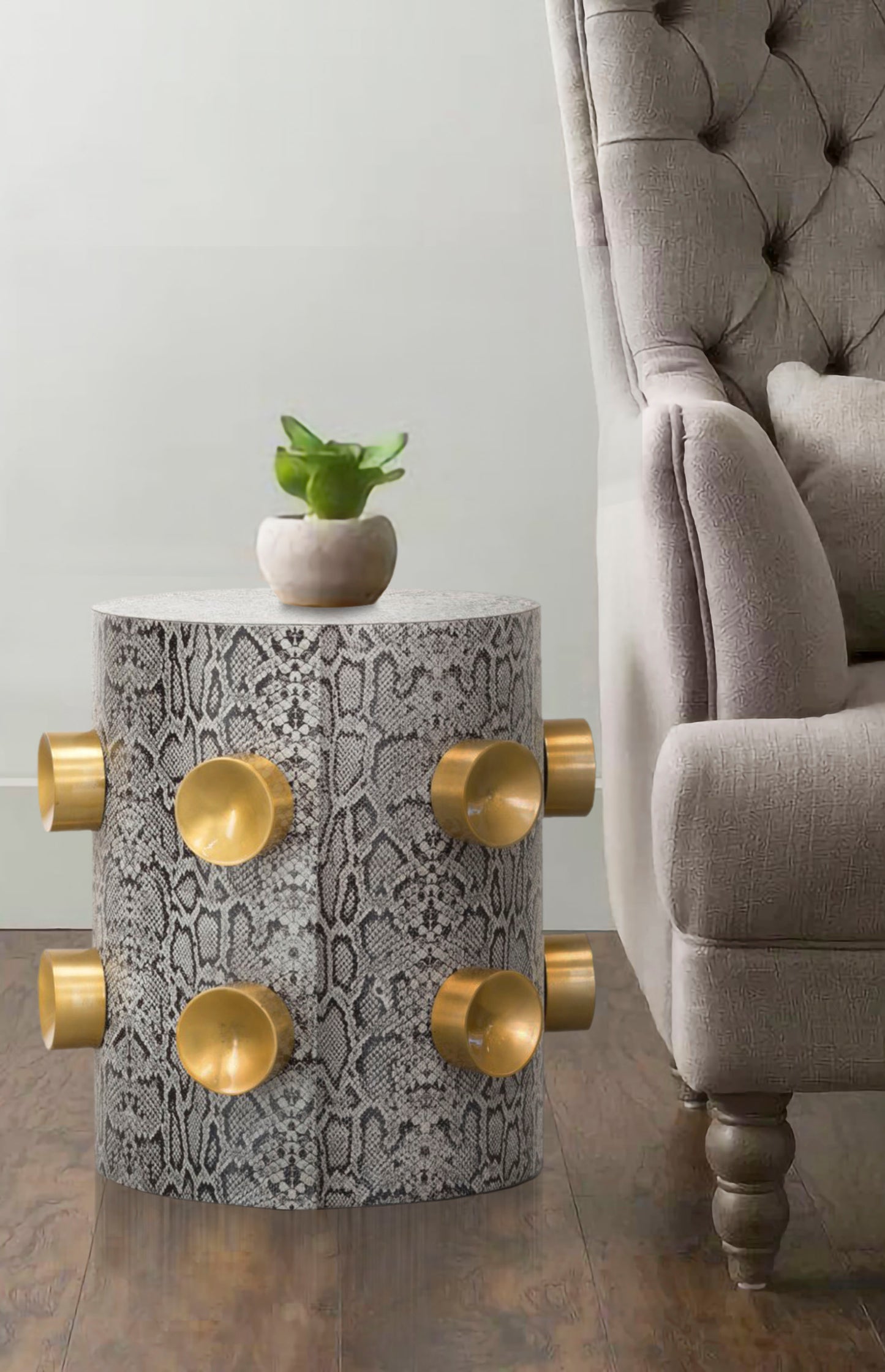 Snakeskin end table with gold buttons.