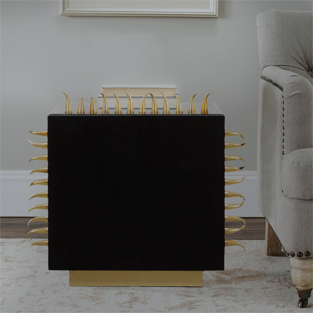 Black leather coffee table with golden spikes.