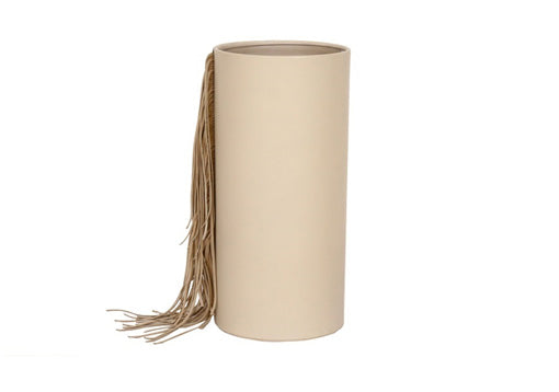 Minimalist leather vase in cream color with fringe detail.