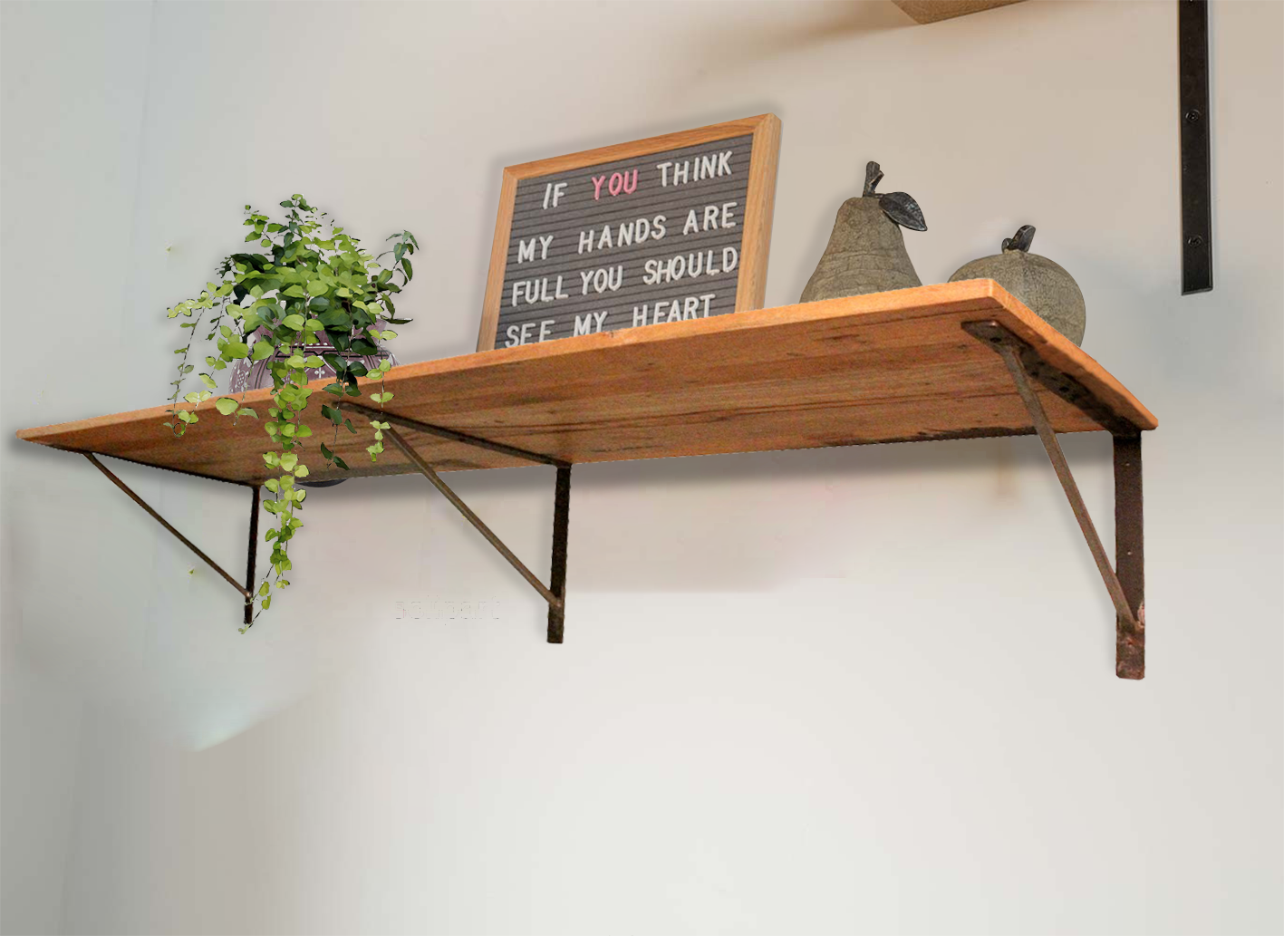 Rustic wooden shelf mounted on a wall with décor.